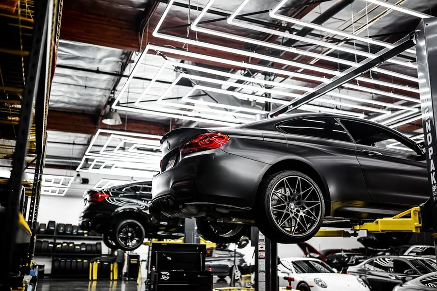 A car raised on the shop alignment rack