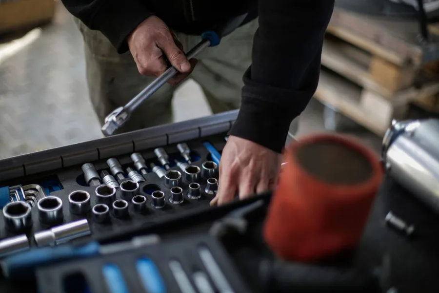 Hands reaching into an organised socket set