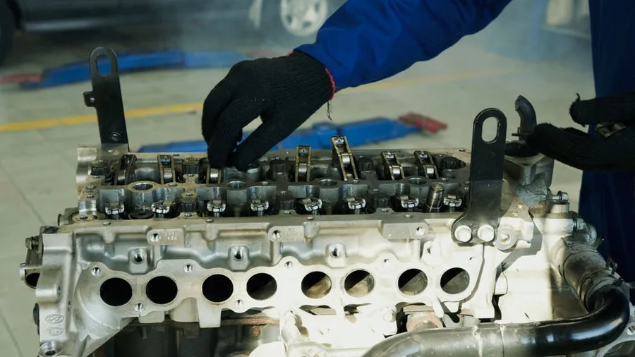 A disassembled cylinder head laid out on the bench