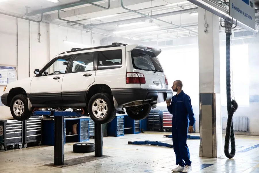 A hatchback on the alignment rack mid-service