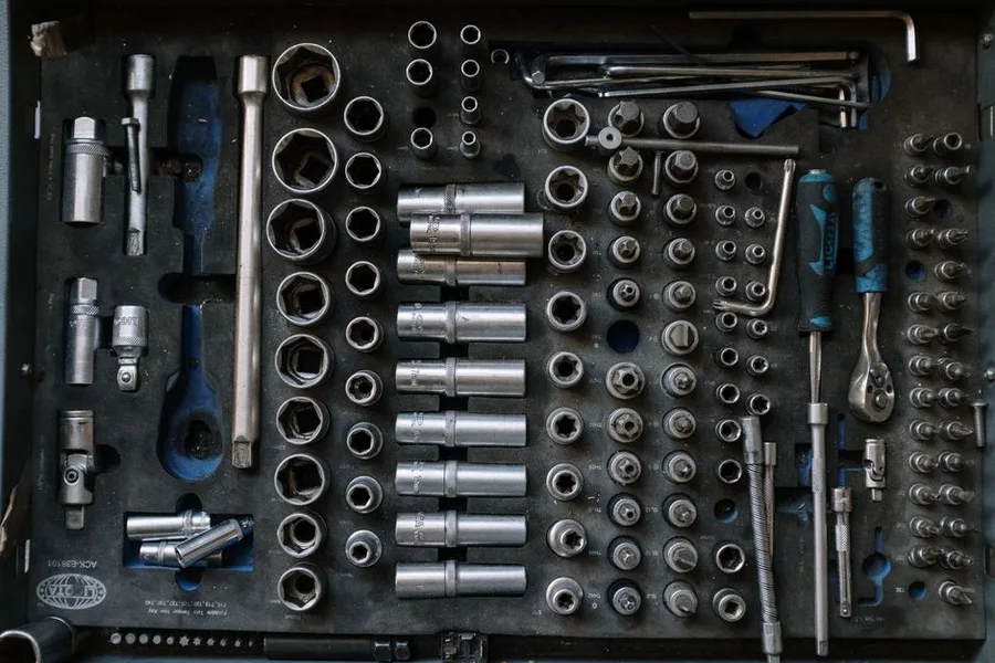 A tool chest drawer of sockets laid out in order