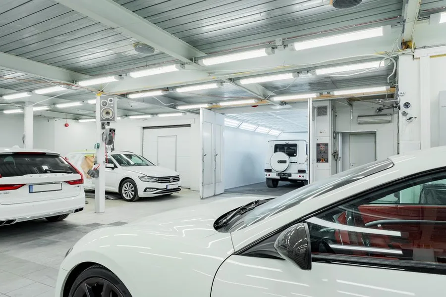The two service bays, bright and clean, cars on lifts