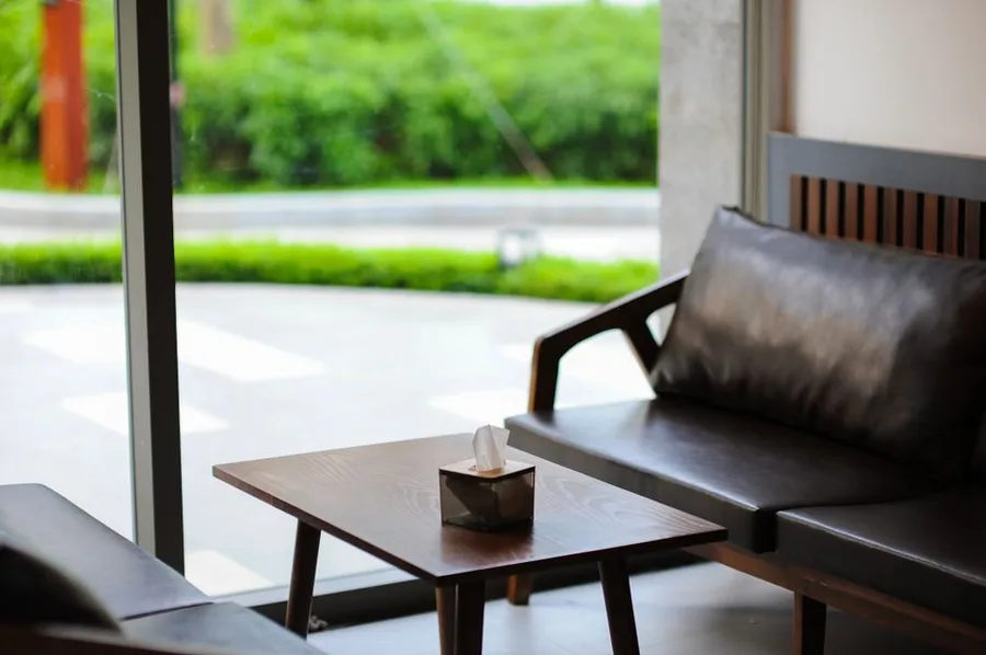 A seating area by the window in the customer lounge